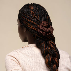 Person with hair styled in a half-up look using the Satin Rosette Medium Flat Cloud Clip in Chocolate