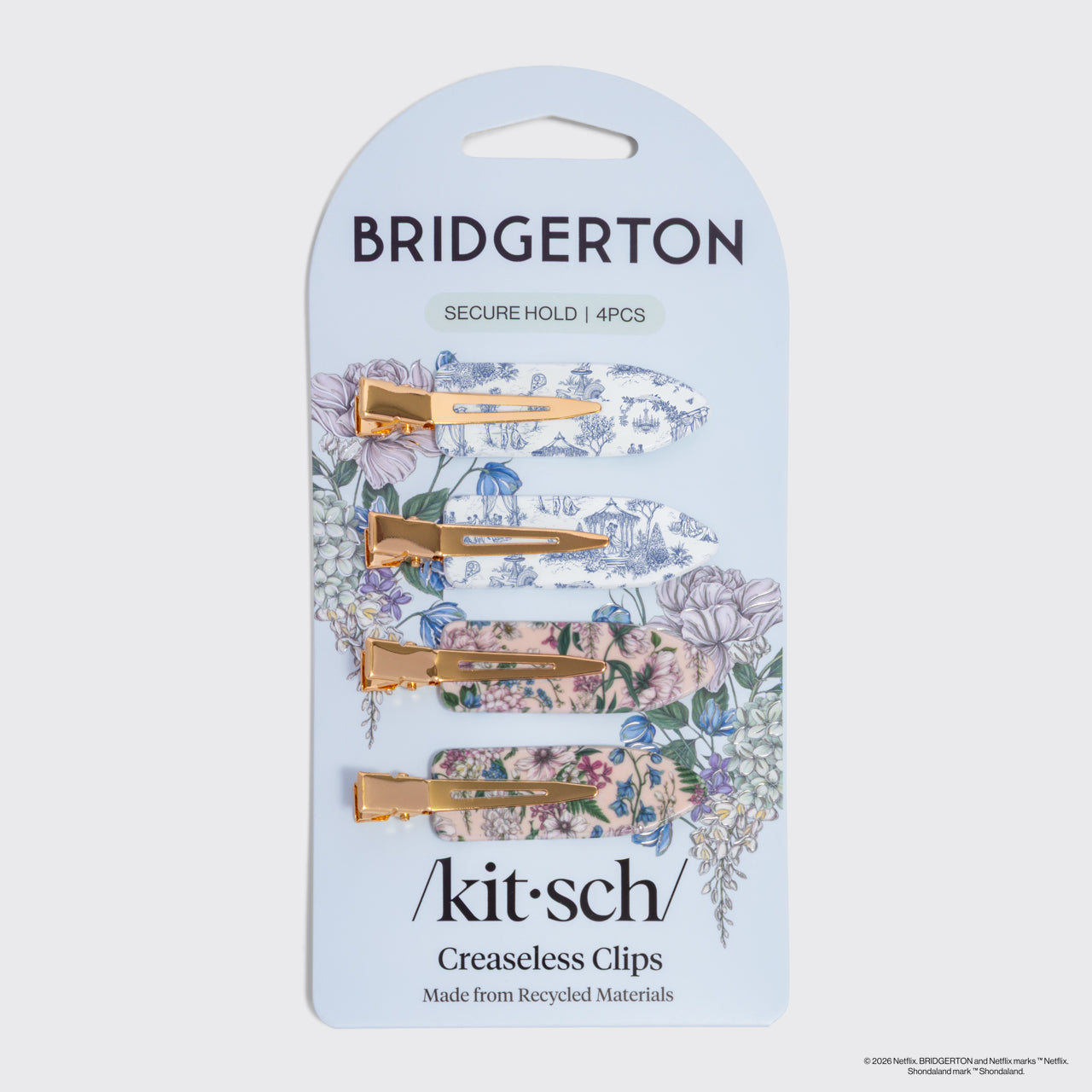 Bridgerton x Kitsch Creaseless Clips in Toile in Bloom, packaging of Bridgerton and kitsch hair clips with floral designs on a gray background.