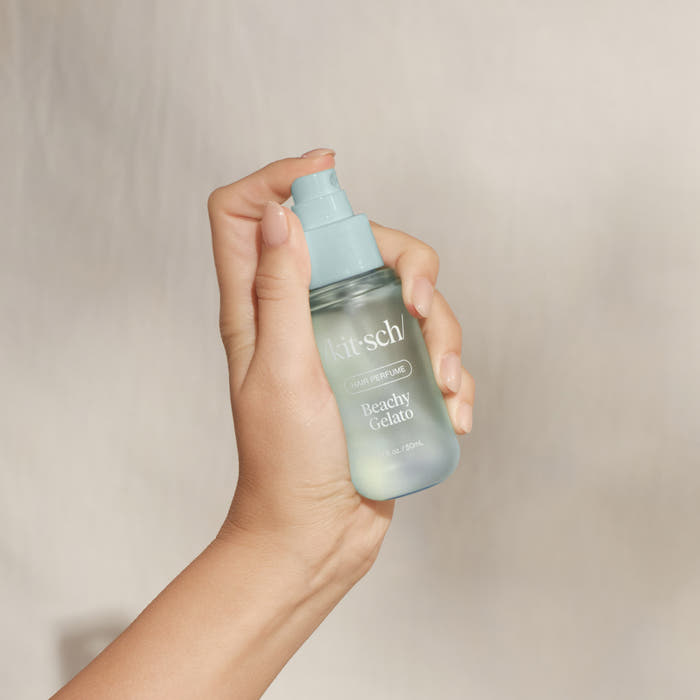 Hand holding Kitsch Beachy Gelato Hair Perfume spray bottle – 1.7 fl oz travel-friendly hair fragrance
