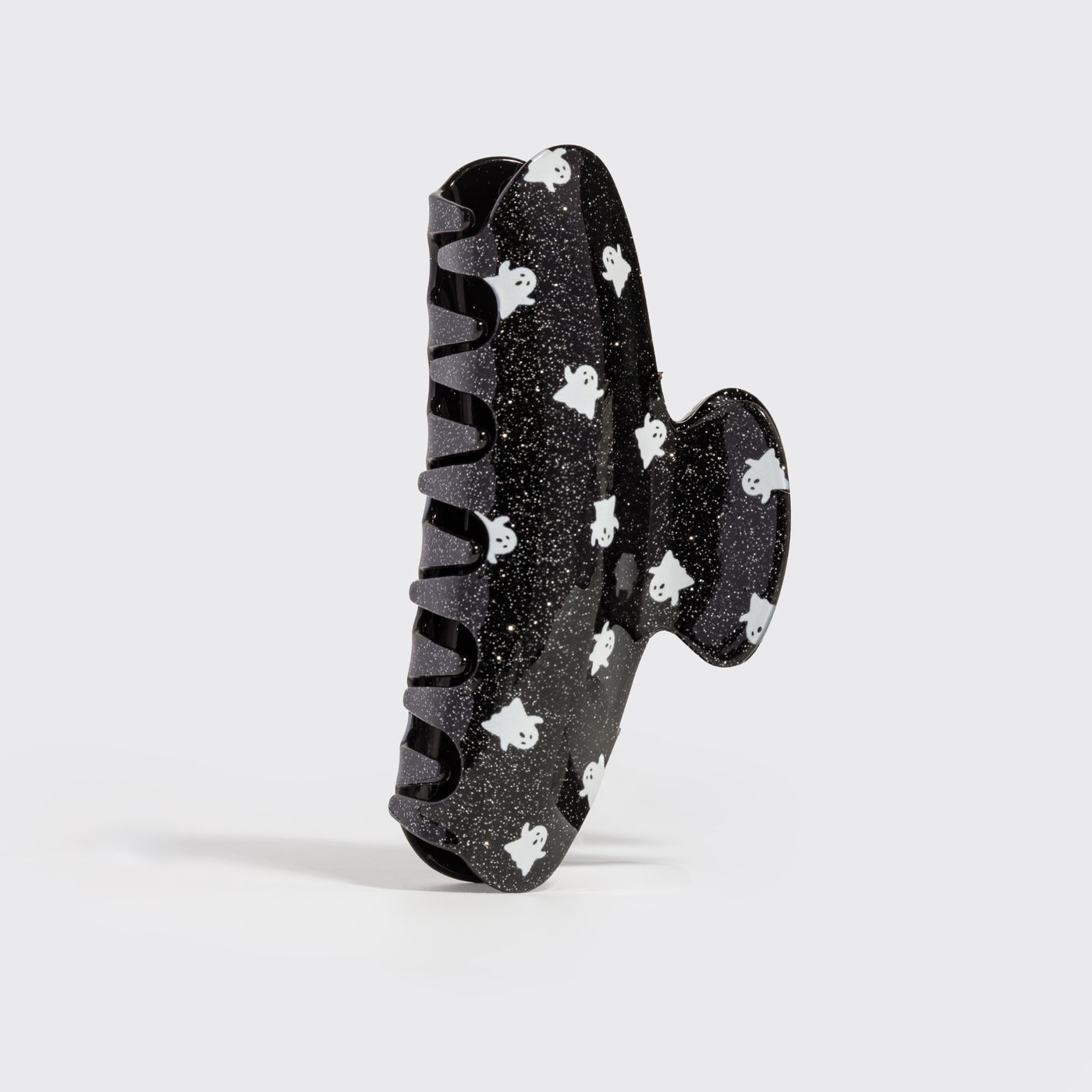 Side view of the Recycled Plastic Glitter Claw Clip in Ghosts with black glitter finish and white ghost pattern.
