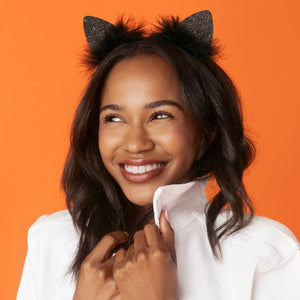 KITSCH Black Glitter Satin Cat Ears Headband — lifestyle model shot styling the cat ears headband — sparkly glitter ears and plush faux-fur trim